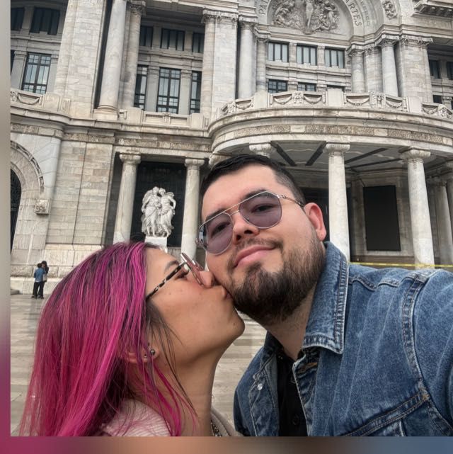 Miguel and Marinelle together in Mexico City in front of a historic building.